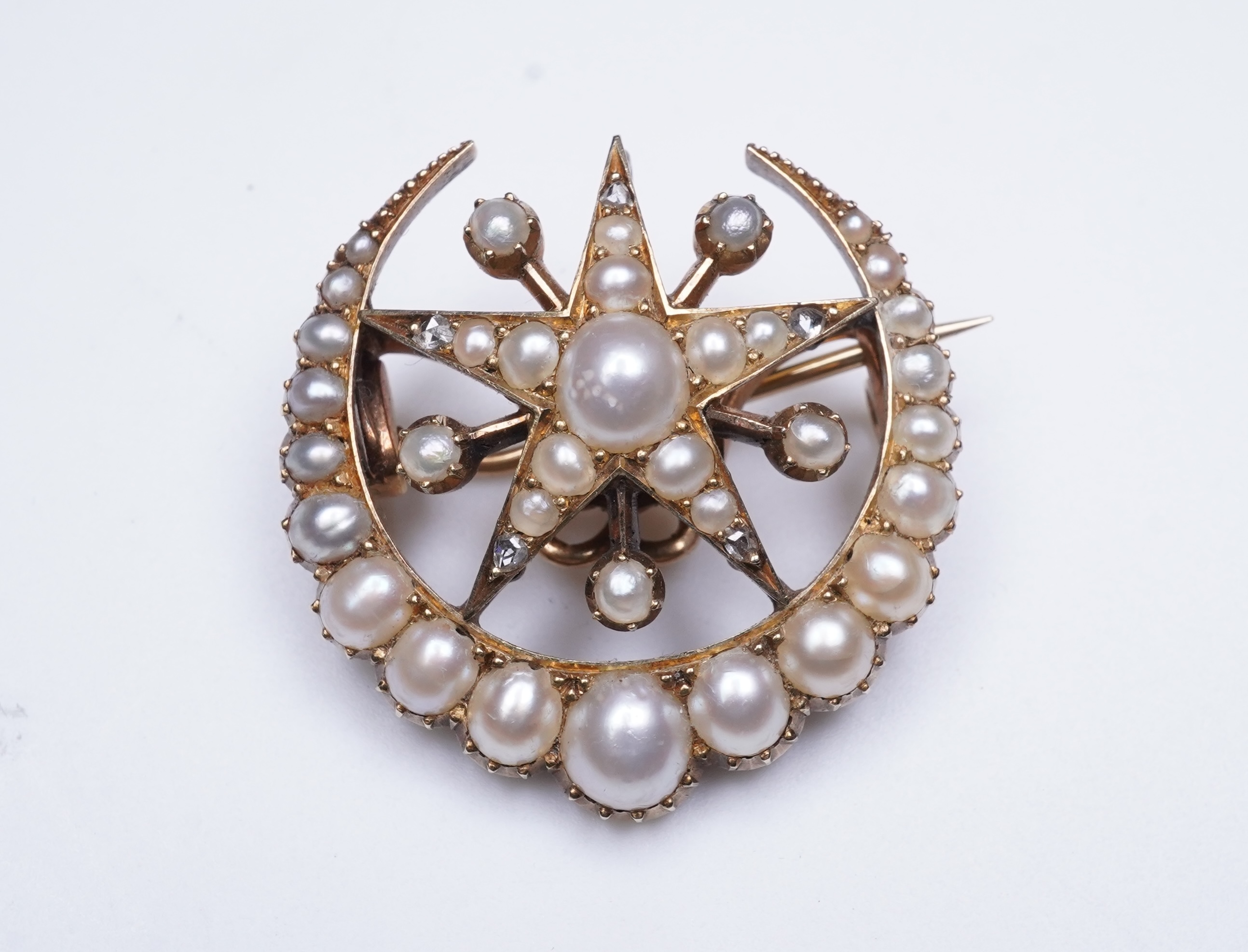 An Edwardian half pearl and diamond brooch, early 20th century